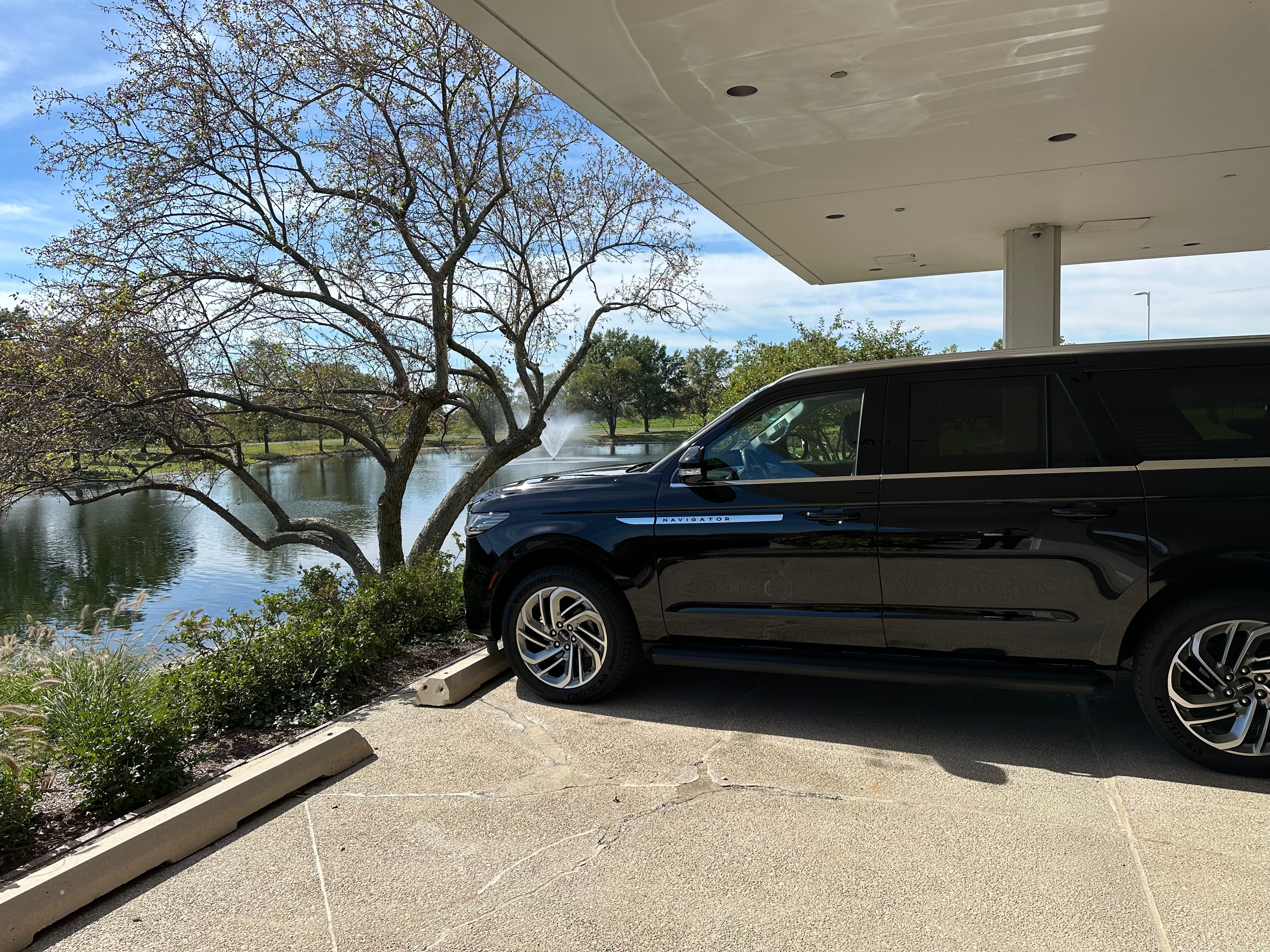 Lincoln Navigator SUV side profile with pond view